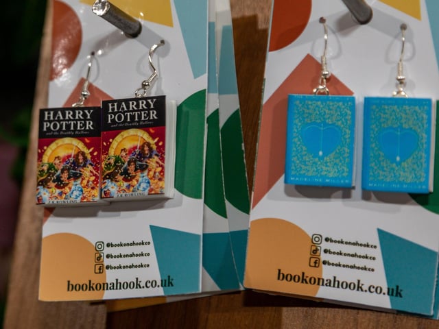 Miniature book earrings by BookOnAHook at the Gosport Christmas market. Picture: Mike Cooter (251123)