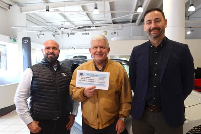 Prize draw winner Raymond Tweddle, centre, with Martin Young, left, Sales Executive at Snows Toyota Waterlooville, and Gareth Taylor, General Manager of Snows’ Toyota dealerships in Waterlooville and Chichester