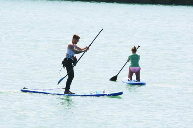 Paddleboarders pictured on the water. Photo by Derek Martin Photography.