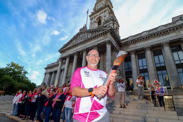 Pictured: George Turner with the Queen's Baton at Portsmouth Guildhall with Spinnaker Choir at the background
Picture: Habibur Rahman