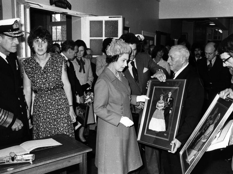 The Queen and Prince Philip are presented with paintings during their visit to Portsmouth in 1980. The News PP5127