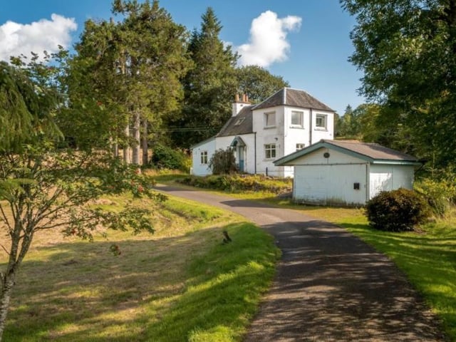 Cowden Cottage is a two storey cottage built on the raised site on the corner of the drive. The main part of the house is harled brick and stone, with a single story wooden lean
