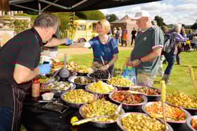 Pictured is:  Ann and Ray purchase some of the delicious olives from stall at the South Downs Food Festival Picture: Keith Woodland (140921-17)