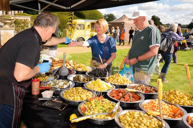 Pictured is: Ann and Ray purchase some of the delicious olives from stall at the South Downs Food Festival Picture: Keith Woodland (140921-17)