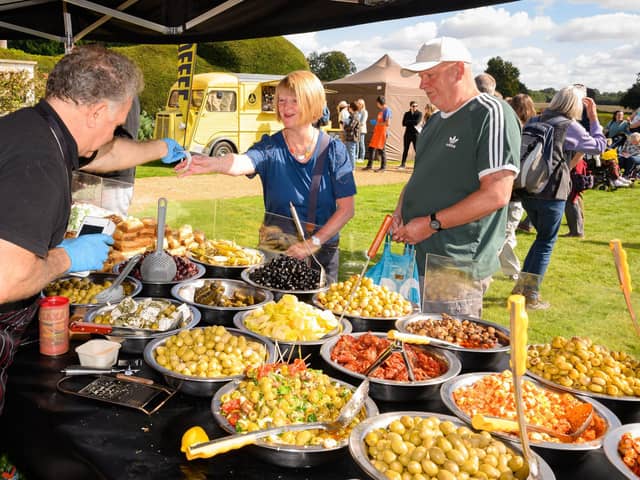 Pictured is:  Ann and Ray purchase some of the delicious olives from stall at the South Downs Food Festival Picture: Keith Woodland (140921-17)