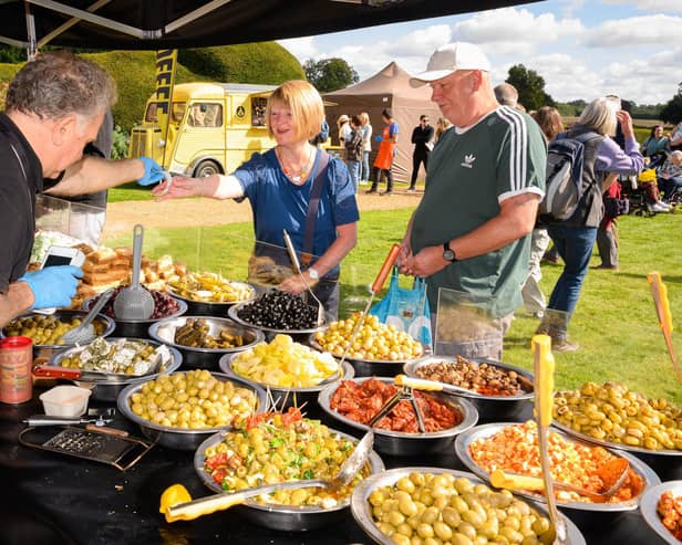 Pictured is:  Ann and Ray purchase some of the delicious olives from stall at the South Downs Food Festival Picture: Keith Woodland (140921-17)