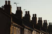 Chimneys on a row of terraced residential houses. Photo credit: Dominic Lipinski/PA Wire