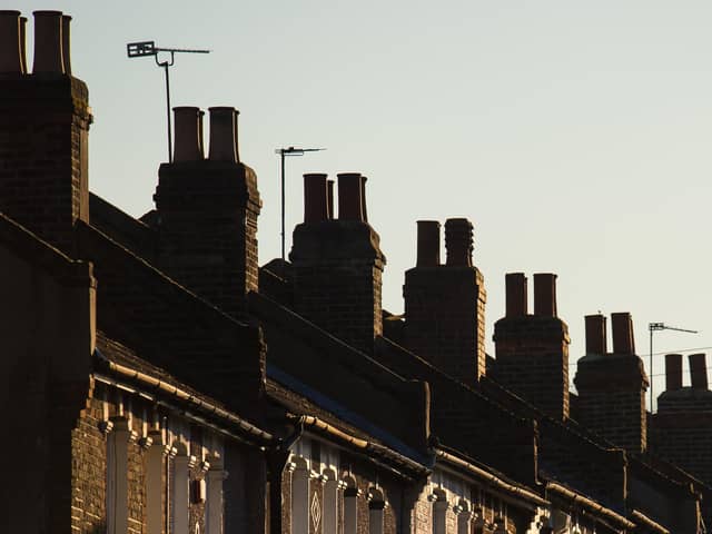 Chimneys on a row of terraced residential houses. Photo credit: Dominic Lipinski/PA Wire