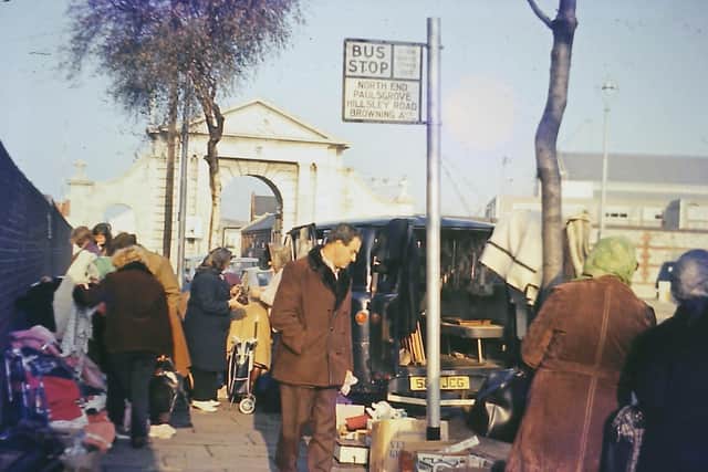 With Unicorn Gate overlooking the scene bargain hunters look for a good deal. The bus stop was only for dockyard workers, hence no route number.