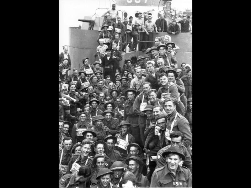 British troops on board an LCI(L) or Landing Craft, Infantry (Large) at South Parade Pier. They will have just boarded and soon to set off for Normandy. The landing craft is operated by the US Navy and several US sailors can also be seen, including an African-American crewman at the rear.