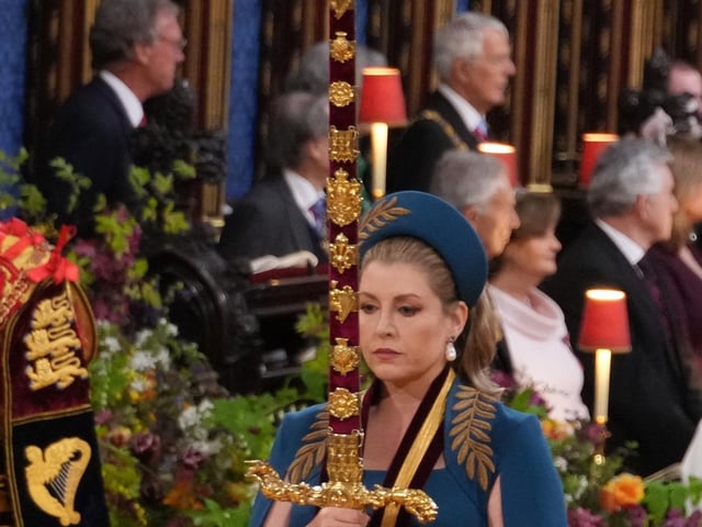Penny Mordaunt thanked her Royal Navy background for being able to carry the swords for over an hour.