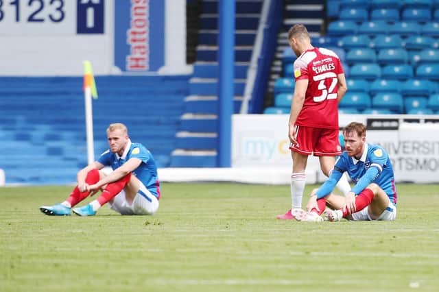 Jack Whatmough and Tom Naylor dejected after Pompey missed out on a play-off place. Picture: Joe Pepler