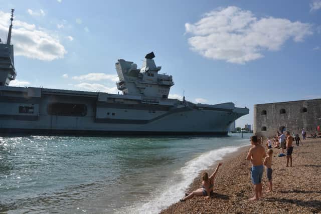 Sunbathers welcome home Royal Navy aircraft carrier HMS Prince of Wales back to Portsmouth on August 26, 2021, in time for the bank holiday weekend after a short period of training. Pic: Ben Mitchell/PA Wire