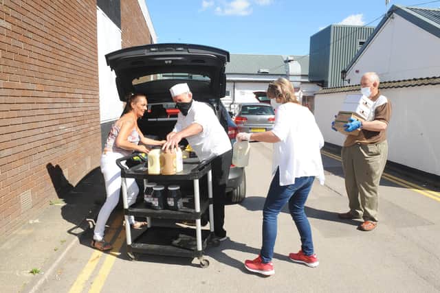 Volunteers from The Lifehouse and Stephen Stockton, senior sous chef from Mill Rythe Holiday Village pack up the cars with donated food.
Picture: Sarah Standing (210720-1579)
