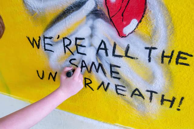 Adding a slogan to the mural. Picture: Habibur Rahman
