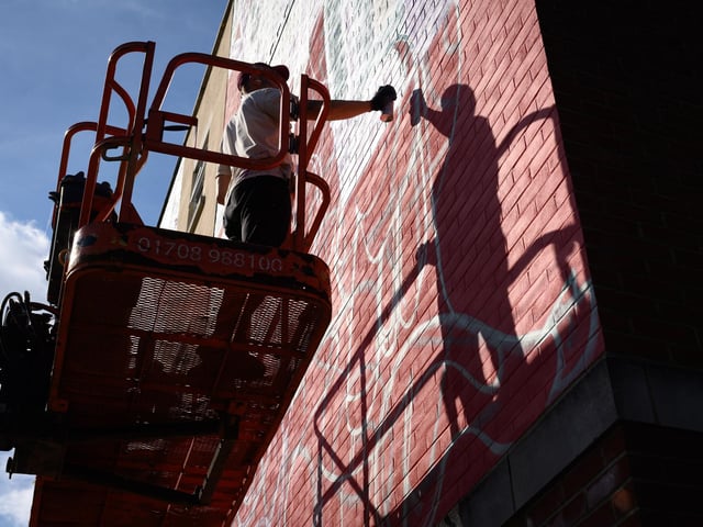 Pictured is: Reka One at work on his creation on the side of 23 St Pauls Road
Picture: Keith Woodland (140921-71)