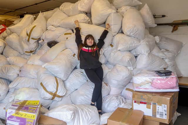 Teagan Pottinger, 13, showing the scale of donations at Jacobs Well Care Centre. Picture: Habibur Rahman.