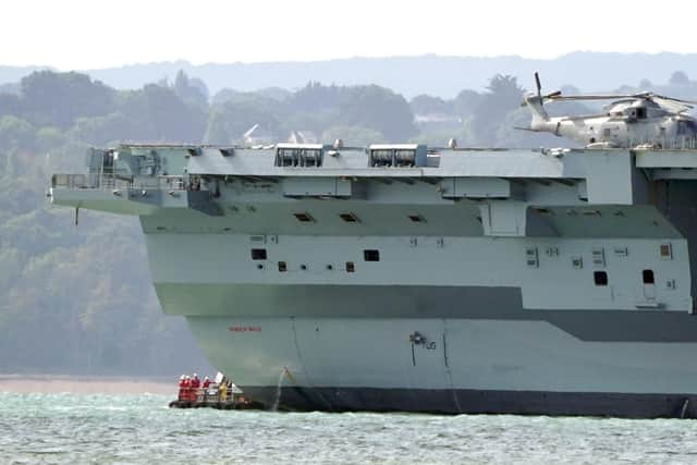 Engineers inspect aircraft carrier HMS Prince of Wales as it sits off the coast of Gosport Picture: Gareth Fuller/PA Wire