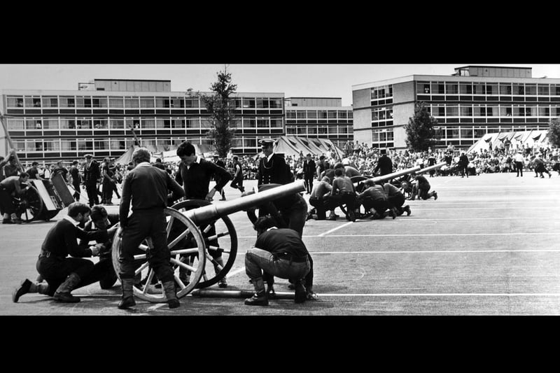 Bob Ayer, in his role as Brickwoods field gun crew battery commander (centre, in white peaked cap) at HMS Collingwood, about 1980.