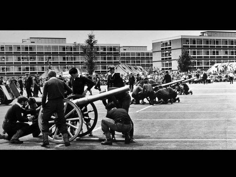 Bob Ayer, in his role as Brickwoods field gun crew battery commander (centre, in white peaked cap) at HMS Collingwood, about 1980.