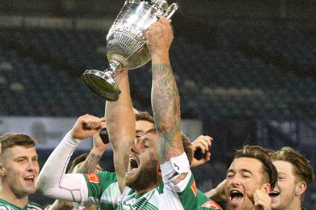 Steve Hutchings holds the Portsmouth Senior Cup aloft after a penalty shoot-out victory over Baffins at Fratton Park in March. Picture: Chris Moorhouse