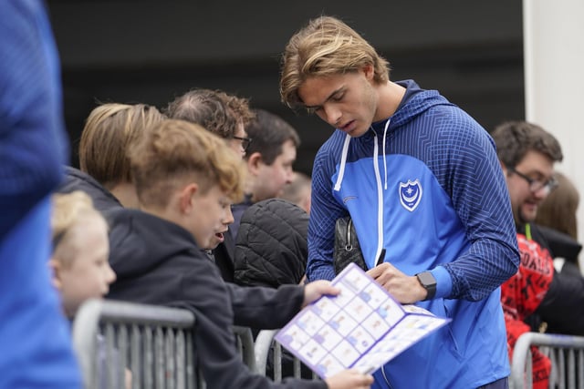 Recalled Ryley Towler look relaxed before kick-off as he signed autographs.