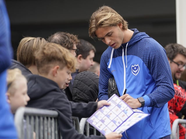 Recalled Ryley Towler look relaxed before kick-off as he signed autographs.