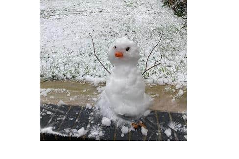 A snowman in the last snowfall