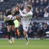 Colby Bishop gets some rough treatment at the hands of MK Dons defender Jack Tucker.