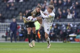 Colby Bishop gets some rough treatment at the hands of MK Dons defender Jack Tucker.