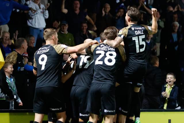 The Pompey players celebrate Sam Hughes' second-half own goal which set them on their way to victory against Burton    Picture: Simon Davies