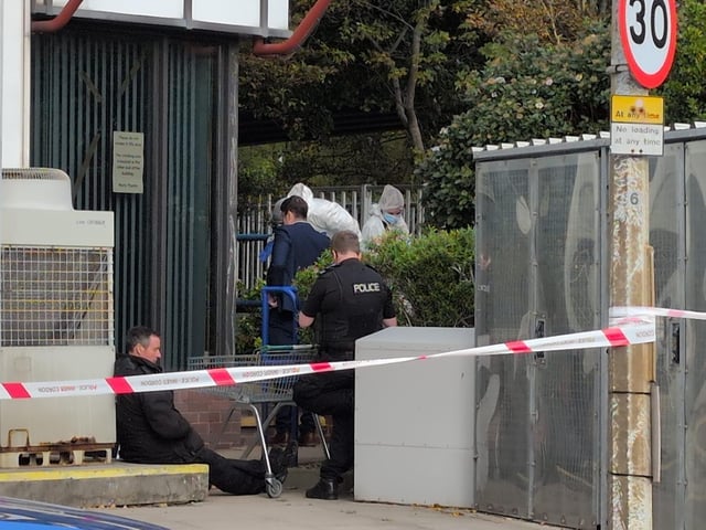 Police at the scene where a dead body was found in Wharf Road