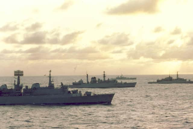 Ships of the Navy Task Force to the Falkland Islands steam south through the Atlantic as dawn breaks in April 1982