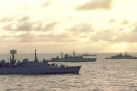 Ships of the Navy Task Force to the Falkland Islands steam south through the Atlantic as dawn breaks in April 1982