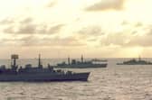 Ships of the Navy Task Force to the Falkland Islands steam south through the Atlantic as dawn breaks in April 1982