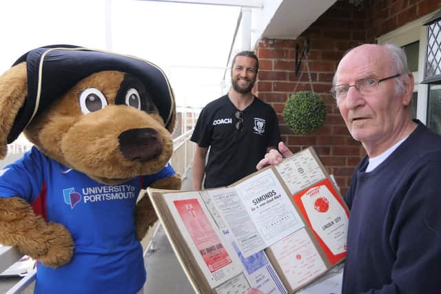 Former Pompey winger John McClelland showed Christian Burgess his programme collection after the Blues defender dropped off his medicine