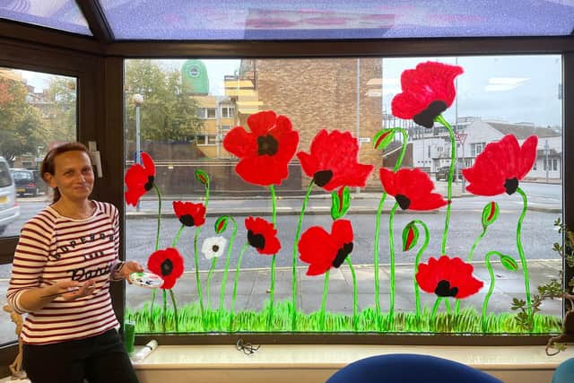 Ukrainian refugee Keira, seen with her stunning poppy scene at City of Portsmouth College's Arundel Campus.