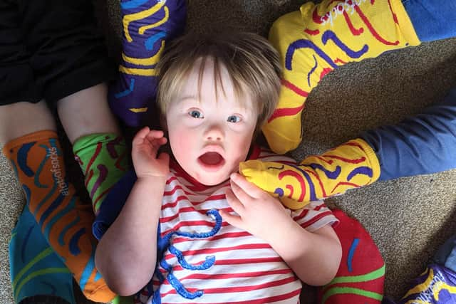 People are supporting Portsmouth Down Syndrome Association by getting involved with the Rock Your Socks awareness campaign by wearing bright socks to celebrate our differences. Pictured: Four-year-old Ted Osborne surrounded by funky socks