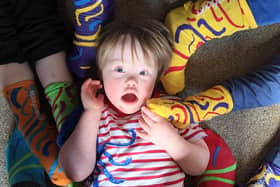 People are supporting Portsmouth Down Syndrome Association by getting involved with the Rock Your Socks awareness campaign by wearing bright socks to celebrate our differences. Pictured: Four-year-old Ted Osborne surrounded by funky socks