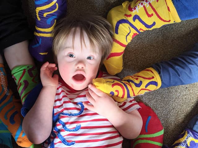 People are supporting Portsmouth Down Syndrome Association by getting involved with the Rock Your Socks awareness campaign by wearing bright socks to celebrate our differences. Pictured: Four-year-old Ted Osborne surrounded by funky socks