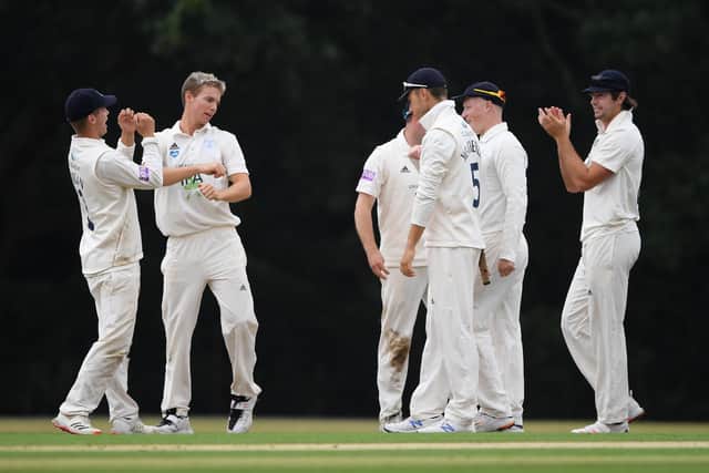 Tom Scriven of Hampshire (second left) celebrates with team mates after dismissing Jamie Smith - his maiden first class wicket. Photo by Mike Hewitt/Getty Images.