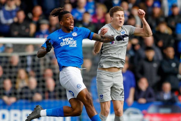 Sean Raggett battles Ivan Toney for the ball during Pompey's loss to Peterborough. Picture: Simon Davies