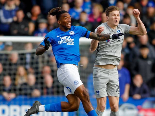 Sean Raggett battles Ivan Toney for the ball during Pompey's loss to Peterborough. Picture: Simon Davies