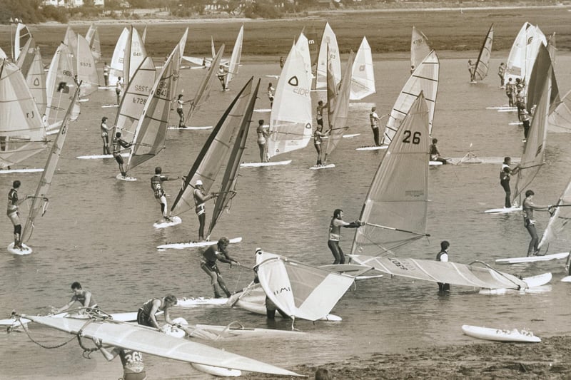 Windsurfers heading to the seas from Northney Marina, Hayling Island, 1988. The News PP5398