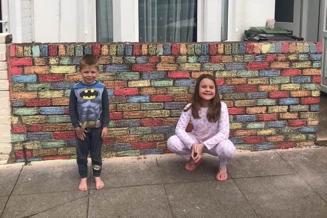 Chloe and Callum Topham, 10 and 5, have brightened up Portchester Road in North End with their colourful chalk design. Pictured: The first creative idea was to colour in the wall outside