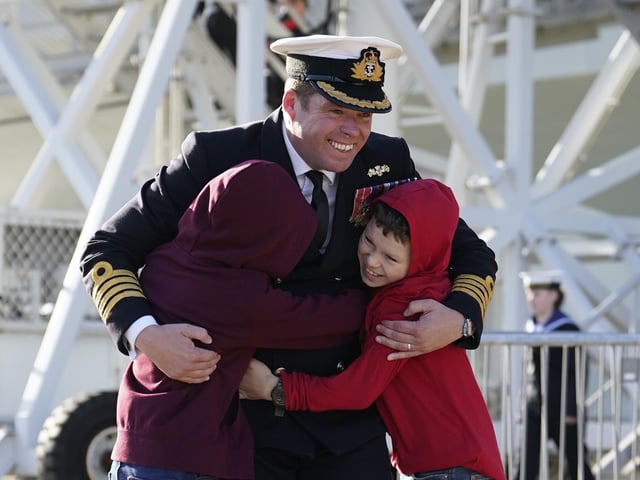 Captain Richard Hewitt, commanding officer of HMS Prince of Wales, is greeted by his sons Oliver and William, after the Royal Navy aircraft carrier returned to Portsmouth Naval Base following it's three-month deployment to the Eastern Seaboard of the United States.