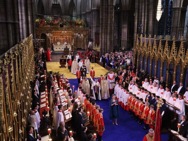 King Charles III with the The Sovereign's Orb as Penny Mordaunt carries the the Sword of State.