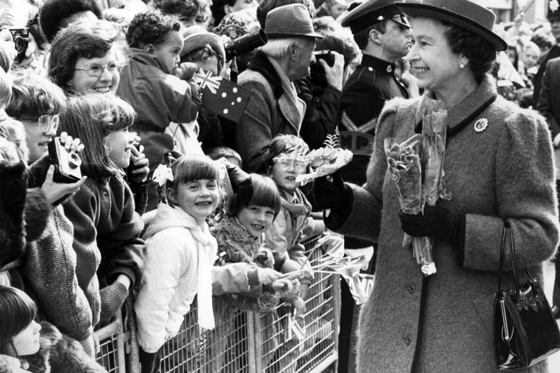 Children press forward to greet the Queen on her walkabout in Portsmouth, 1986. The News PP5122