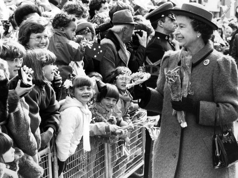 Children press forward to greet the Queen on her walkabout in Portsmouth, 1986. The News PP5122
