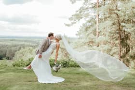 The happy couple at the stunning backdrop of their wedding venue. Picture: Carla Mortimer Wedding Photography